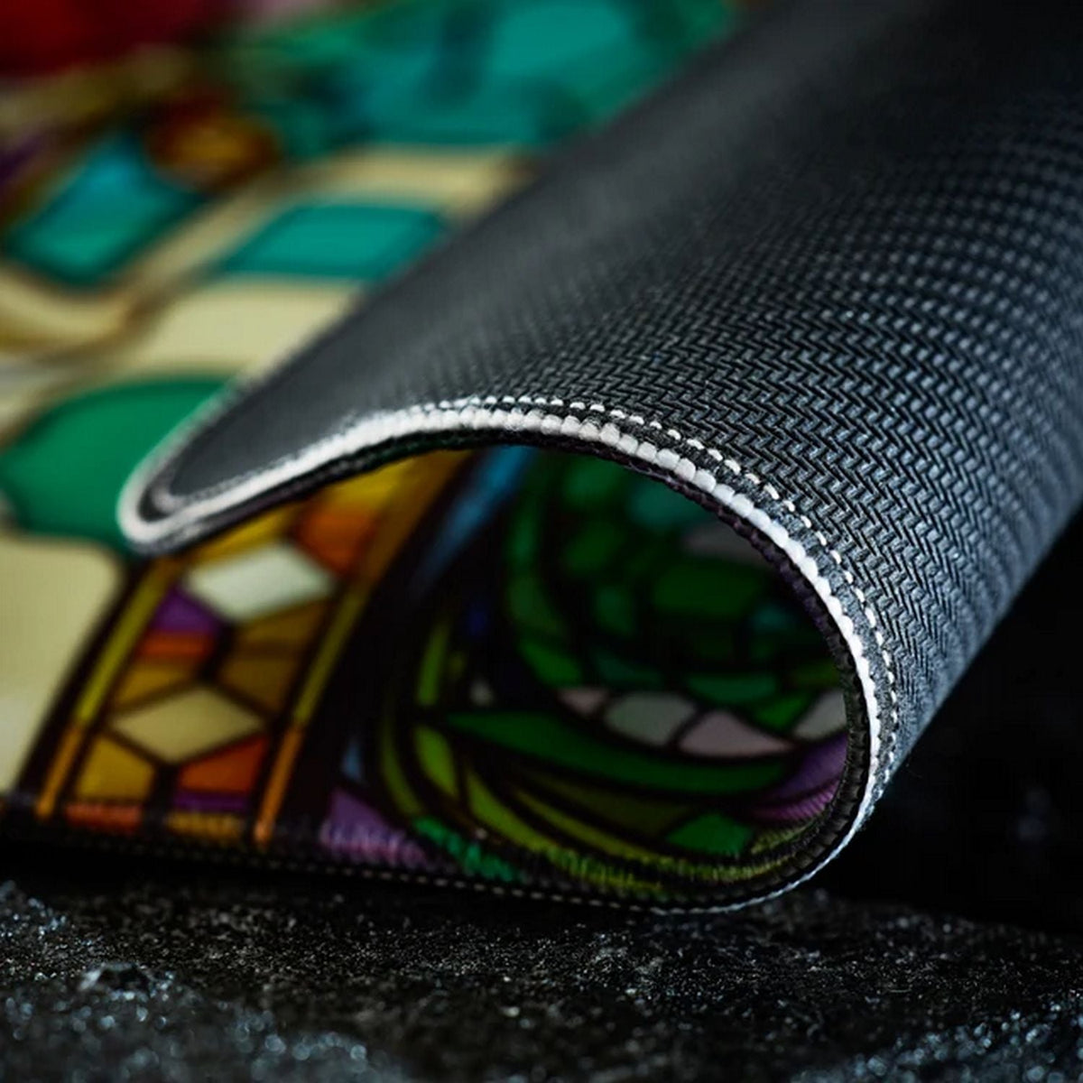 Dragon Shield Dragonfall 2026 Playmat corner rolled to show non-slip rubber backing